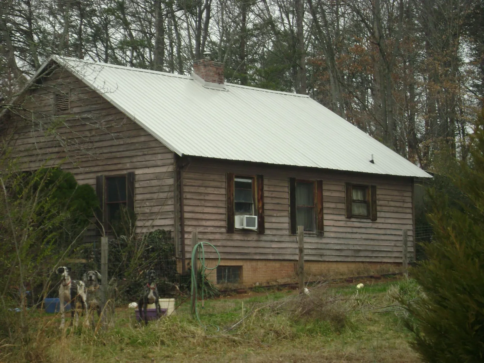 White metal roof on an old wood sided farmhouse, from a Metal Roof Installation job in Ellisburg